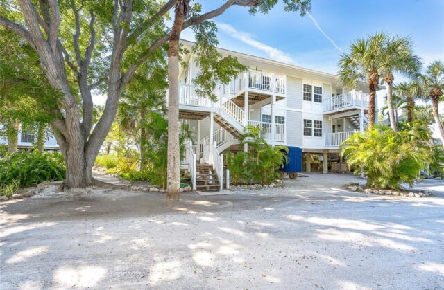 Beachfront villa with lush greenery near Sarasota - perfect to buy a house on a private island.